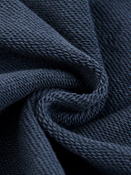 Close-up of dark blue fabric with a textured pattern
